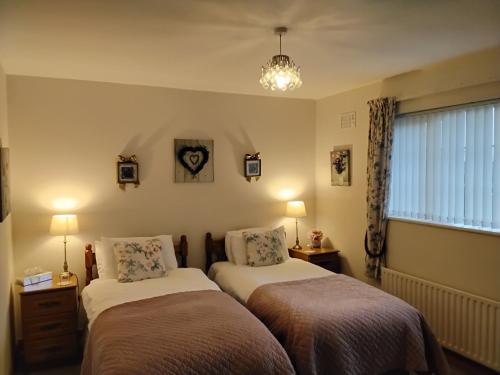 Un pat sau paturi într-o cameră la Hawthorn Lodge