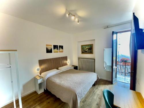 a bedroom with a bed and a large window at Hotel S. Ercolano in Perugia