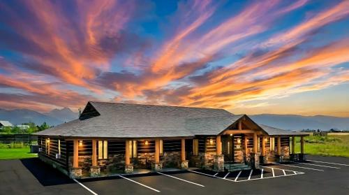 un edificio con una puesta de sol en el fondo en Teton Crest Lodge Sleeps 24 Ideal Reunion Spot, en Driggs