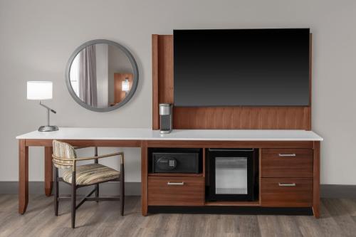 a room with a desk with a tv and a chair at DoubleTree by Hilton New Orleans in New Orleans