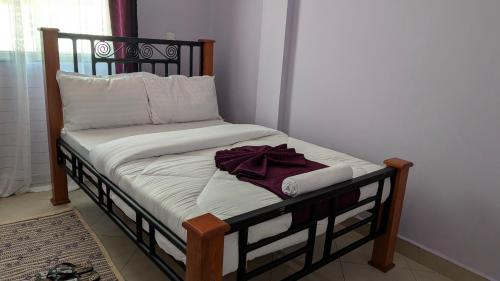 Postel nebo postele na pokoji v ubytování Kilimanjaro Helichrysum Homes