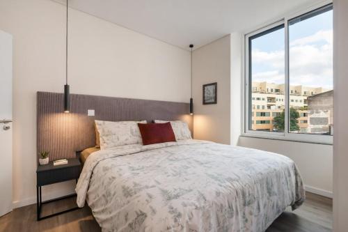 a bedroom with a large bed and a large window at Boutique in Funchal