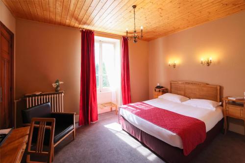 a bedroom with a bed and a desk and a window at Best Western Grand Hotel de Paris & Spa in Villard-de-Lans