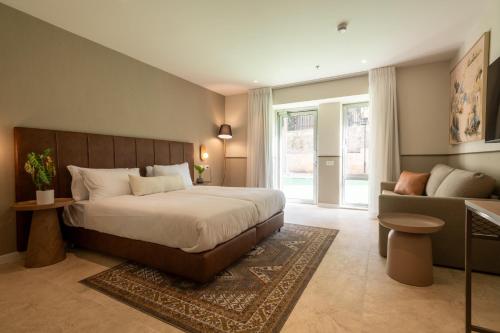 a bedroom with a large bed and a couch at Hotel Beit Shmuel in Jerusalem
