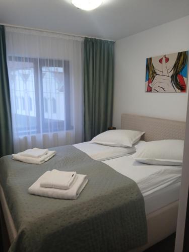 a bedroom with two beds with towels on them at Ama Studio in Buşteni