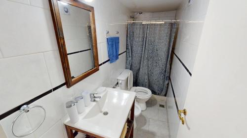 een badkamer met een wastafel, een toilet en een spiegel bij Casa Tipo Loft- Tigre Centro Con Jardin, Parrilla Y Pileta de Lona Grande 4 Personas in Tigre
