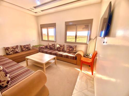a living room with a couch and a table at Dakhla sky blue in Dakhla