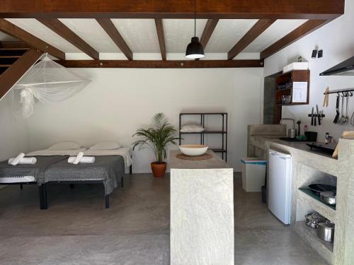 a bedroom with a bed and a kitchen with a sink at Global Chill Farm Loft in Rogil