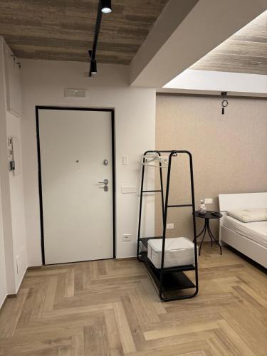 a room with a ladder and a bed and a door at Bed and Breakfast inCentro - Pontecagnano in Pontecagnano