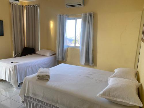 Postel nebo postele na pokoji v ubytování The One Suíte