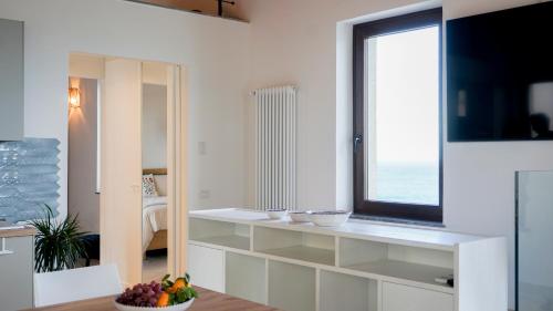a kitchen with a window and a counter with bowls on it at Palazzo Cettina Sul Mare in Cefalù