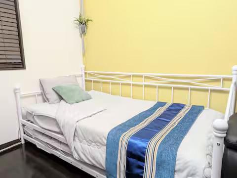 Postel nebo postele na pokoji v ubytování ランドリーデザインハウス