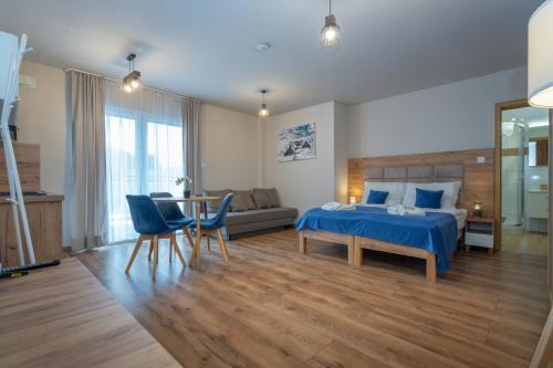 a bedroom with a bed and a couch and a table at Apartamenty Pruskie in Karpacz
