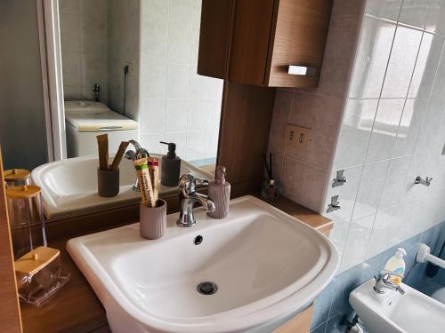 a bathroom with a sink with toothbrushes at Traiano 49 in Turin