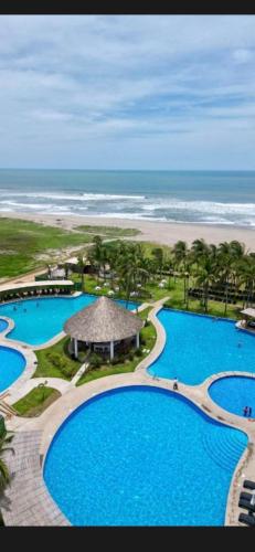 an aerial view of a resort with two pools and a beach at Puerta Al Sol Zona Diamante in Acapulco