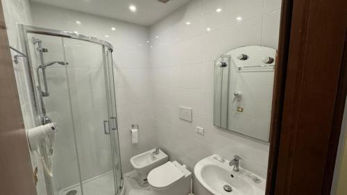a bathroom with a shower and a toilet and a sink at moonstar guesthouse termini in Rome