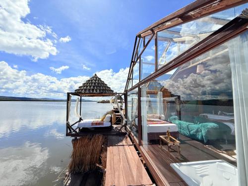a boat that is sitting in the water at Hotel - Titicaca Dora in Puno