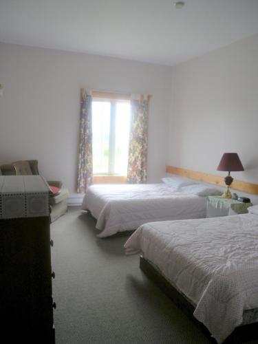 a bedroom with two beds and a window at Wildberry North in Raleigh