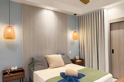 a bedroom with a bed and two lights at Panorama Lake in Punta Cana