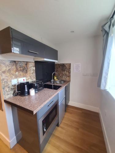 a kitchen with a sink and a counter top at City Centre Studios in Newcastle upon Tyne