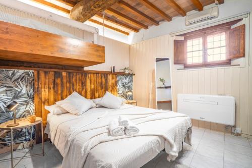 a bedroom with a large bed with shoes on it at Pura Apartment Hill View Stay near Peccioli & Lajatico in Palaia