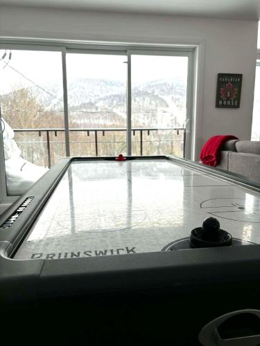 a swimming pool in a living room with a window at Nature & Breathtaking View - Le Dumont - A in Saint-Philémon