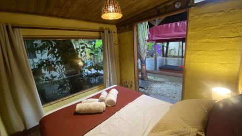 En eller flere senge i et værelse på Casa Holy Ubatuba - Hospedagem Holística