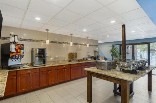 a large kitchen with wooden cabinets and a counter top at Best Western Sky Valley Inn in Monroe