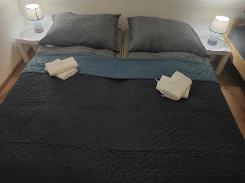 a large bed with two pillows on top of it at APARTMÁN KATKA Liptovský Mikuláš in Liptovský Mikuláš