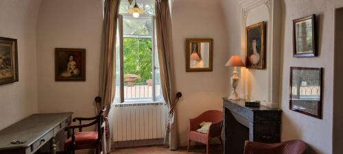 a living room with a desk and a window at Château Meilhen in Les Mages