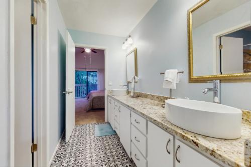 a white bathroom with a sink and a mirror at Horseshoe Bay Getaway in Horseshoe Bay