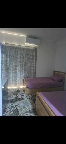 En eller flere senge i et værelse på Hurghada Alhelal