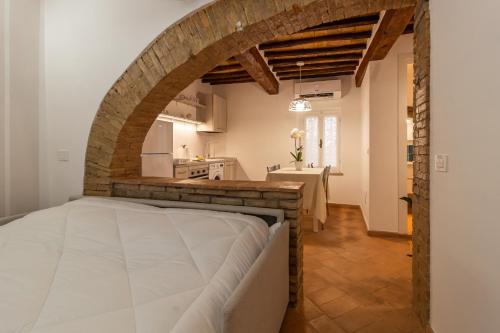 eine Küche und ein Wohnzimmer mit einem Bett in einem Zimmer in der Unterkunft La casetta dell'amore di Mimmi in Castel Viscardo