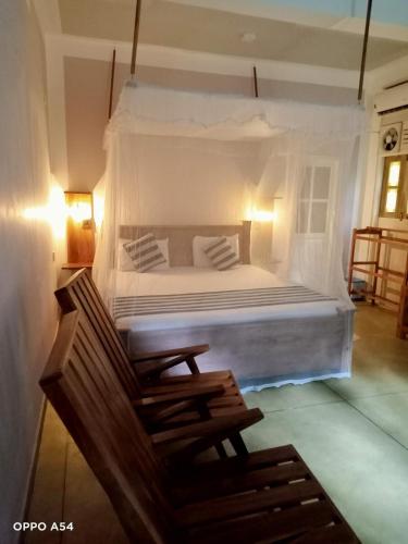 a bedroom with a large bed with white sheets and pillows at Blue Lake Ridge in Maha Oya