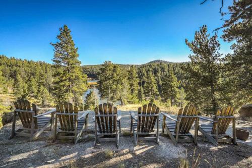 a group of chairs sitting around a table with a view at CrazyHornChalet in Divide