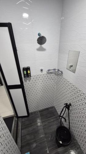 a bathroom with a black toilet in the corner at SSHomestay in Skudai