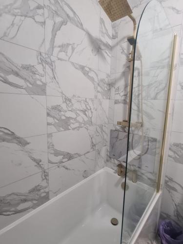 a bathroom with a shower and a bath tub at Modern one bed close to city in Sunderland