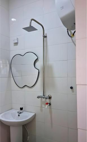 a bathroom with a sink and an apple sign on the wall at J-D Suites in Ozuoba