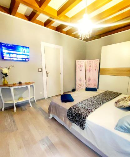 a bedroom with a large bed and a table at L'Andalouse in Vailly-sur-Sauldre