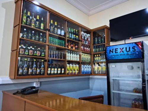 a bar with a lot of bottles of beer at J-D Suites in Ozuoba