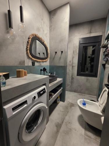 a bathroom with a washing machine and a sink at Mimis Skyline in Xanthi