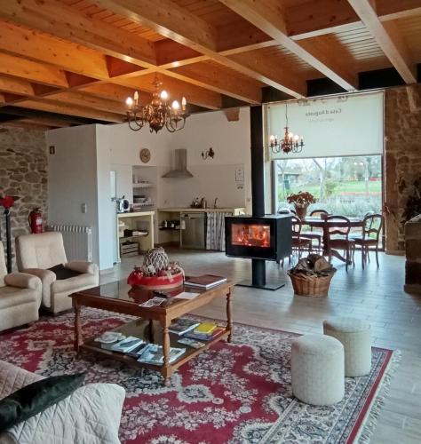 a living room with a table and a fireplace at Casa D'Augusta - Agroturismo in Miranda do Douro