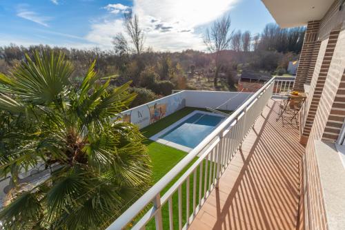 a balcony of a house with a swimming pool at La Villarina in Sitrama de Tera