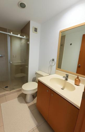a bathroom with a toilet and a sink and a shower at Residence Polanco, Security24h, Balcony, Pool, Gym, CarPark in Mexico City