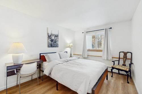 a bedroom with a bed and a desk and a chair at The Woods Village 1 in Killington