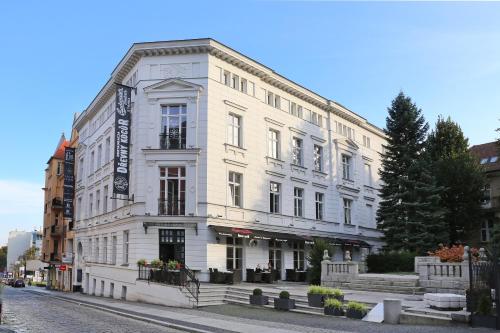 a white building on the side of a street at Fortune boutique old town in Poznań