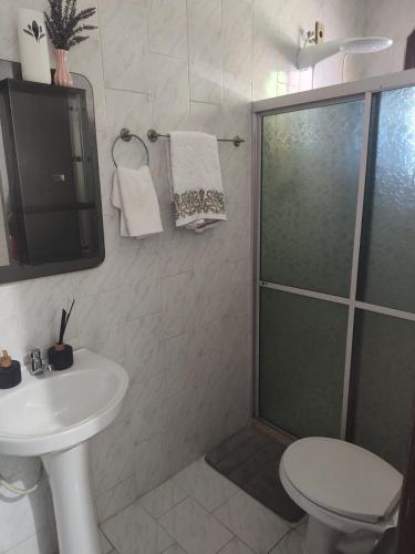 a bathroom with a shower and a sink and a toilet at Pousada Imperatriz in Itaparica