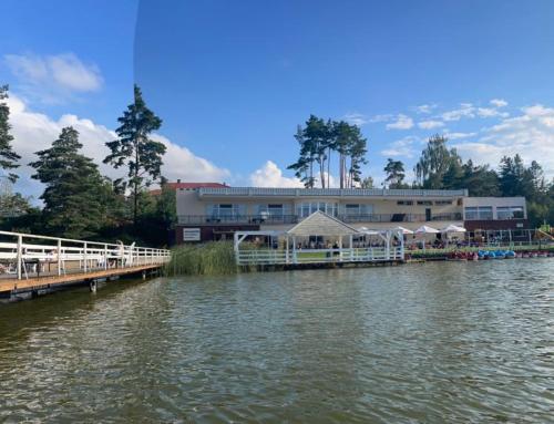 a building with a pier next to a body of water at Leśny Sentyment na Gwizdówce na Kaszubach in Załakowo