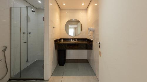a bathroom with a sink and a mirror at St Charbel by Charlie in São Paulo