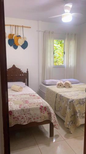 a bedroom with two beds and a window at Sítio recanto do Saltinho Santa teresa -ES in Santa Teresa